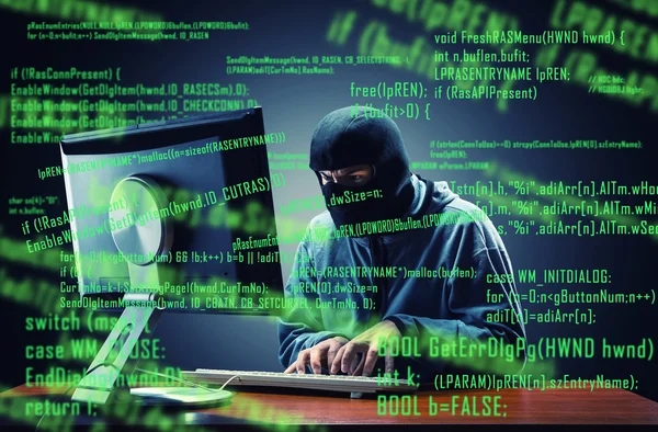 Hacker in mask stealing information