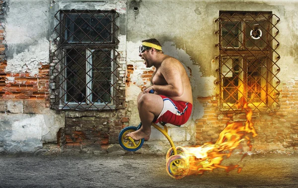 Man cycling on child's bicycle