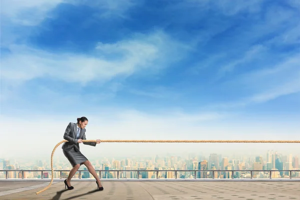 Businesswoman pulls rope