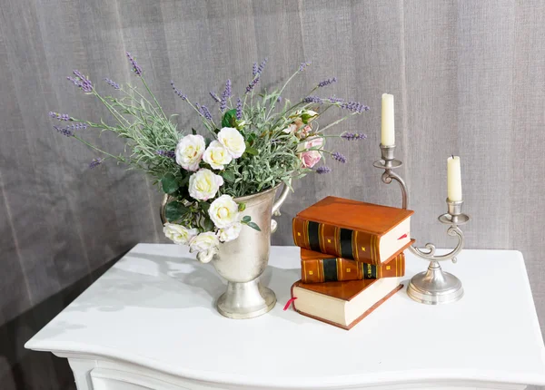 Flowers, books and a candlestick
