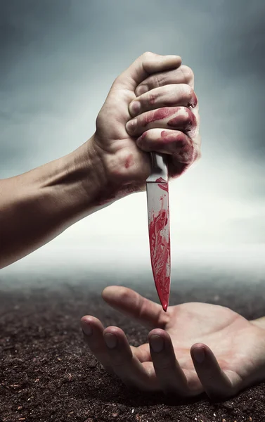 Bloody hand with knife