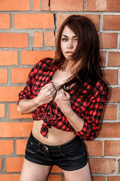 Beautiful young woman in a checked shirt