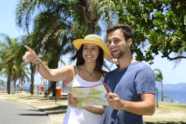 Happy tourist couple with map