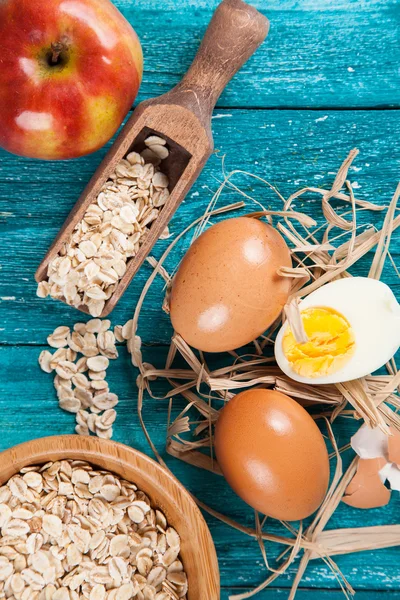 Organic eggs on blue wood background