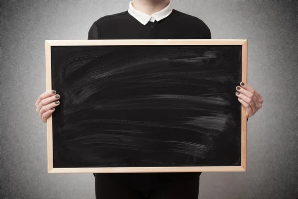 Woman holding a blackboard