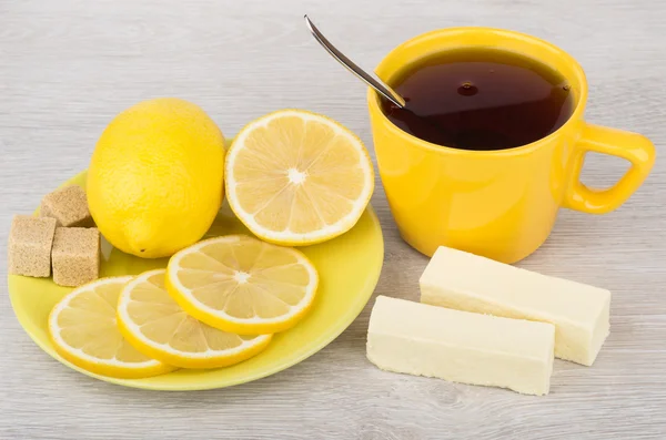 Tea with candy, lemon and sugar