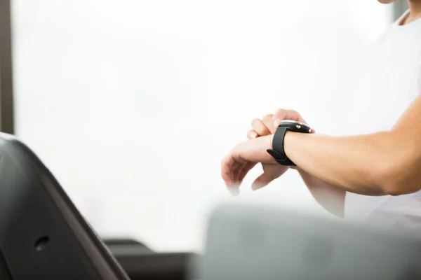 Asian man works out in modern gym