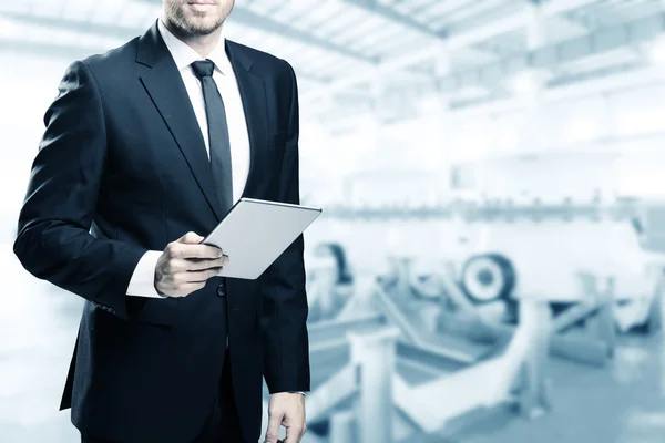 Double exposure of businessman with tablet