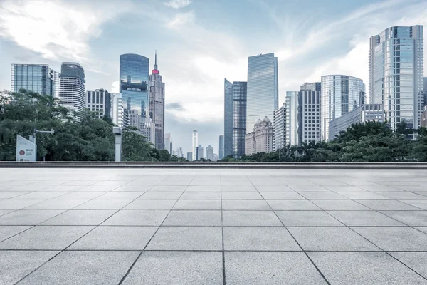 Empty marble floor with cityscape and skyline