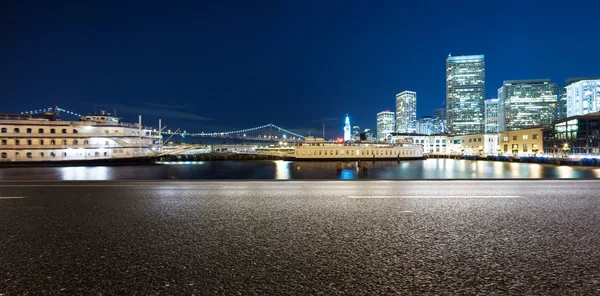 Empty road with buildings near water in San Francisco