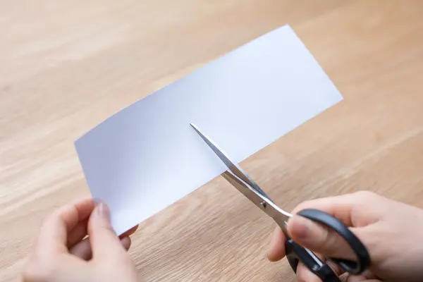 Woman cutting white paper