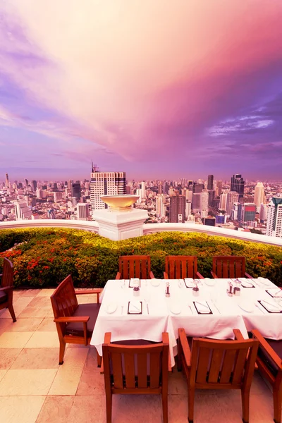 Rooftop restaurant with cityscape background