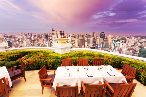 Rooftop restaurant with cityscape background