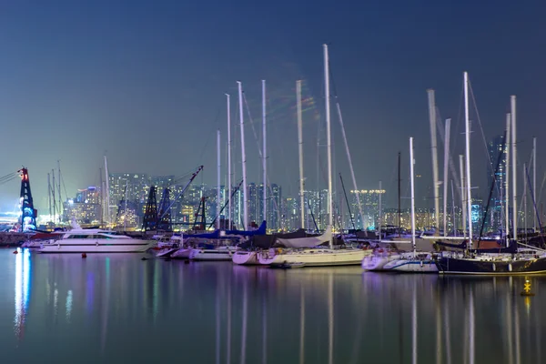 Yachts in harbor at night