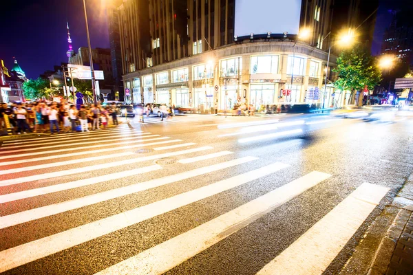 Crowded road with zebra crossing and gymnasium