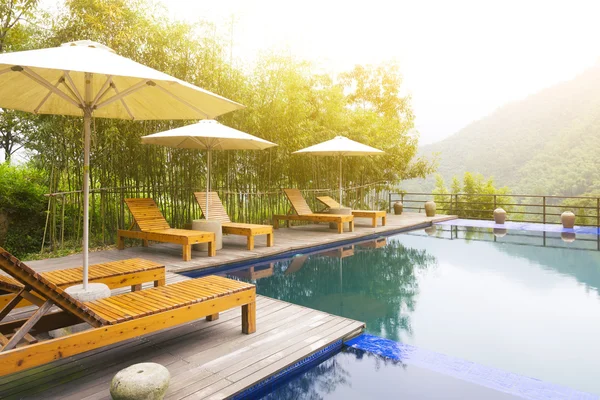 Umbrella chair in hotel pool resort