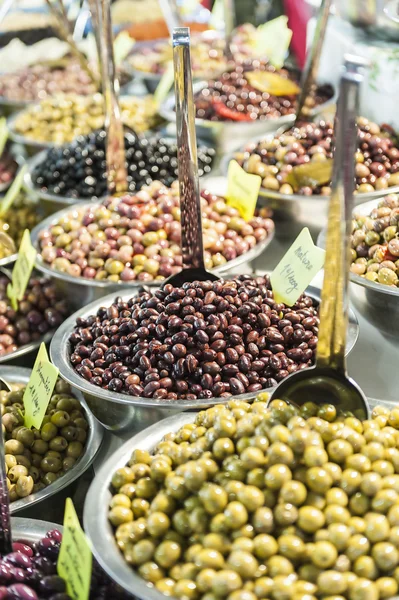 Different marinated olives on street market