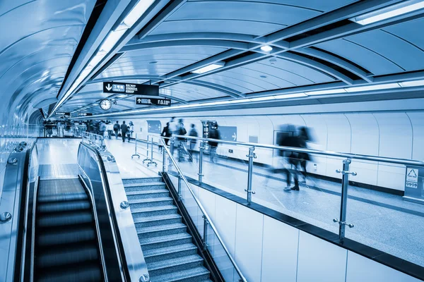 Subway passage with commuters motion blur