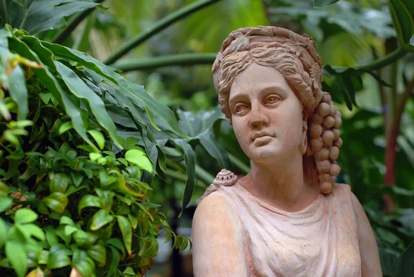 Garden statue of woman with grapes