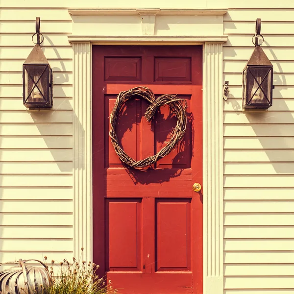 Heart shaped wreath on red door