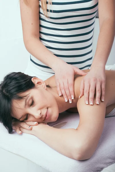 Young attractive girl having head massage at spa resort