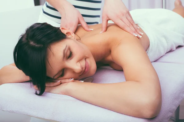 Young attractive girl having head massage at spa resort