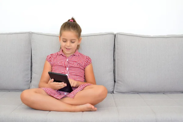 Adorable girl learning with her tablet device