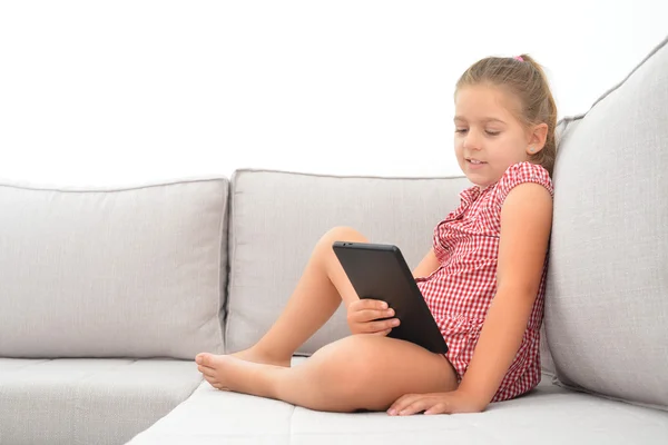 Adorable girl learning with her tablet device