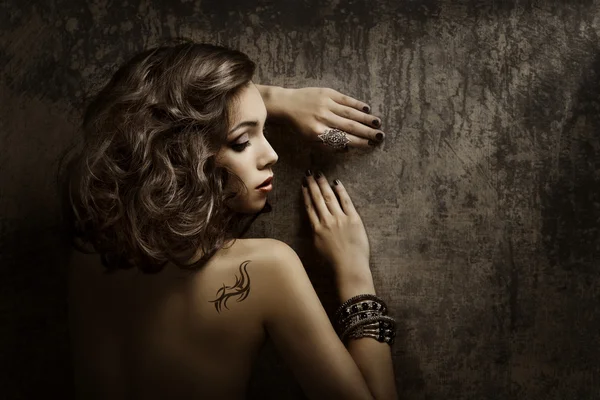 Woman Tattoo on back shoulder, sexy girl beauty fashion portrait over grunge background
