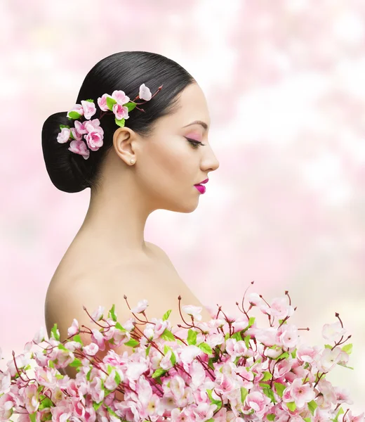 Woman Beauty Portrait in Sakura Flower, Asian Girl Bun Hairstyle, Beautiful Model Over Pink Background