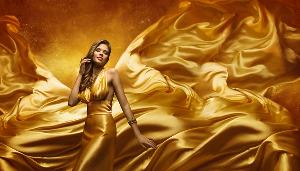 Fashion Model Gold Dress, Beauty Woman Posing, Flying Waving Cloth, Yellow Silk Fabric