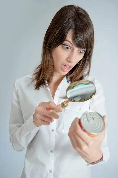 Shocked woman inspecting a nutrition label