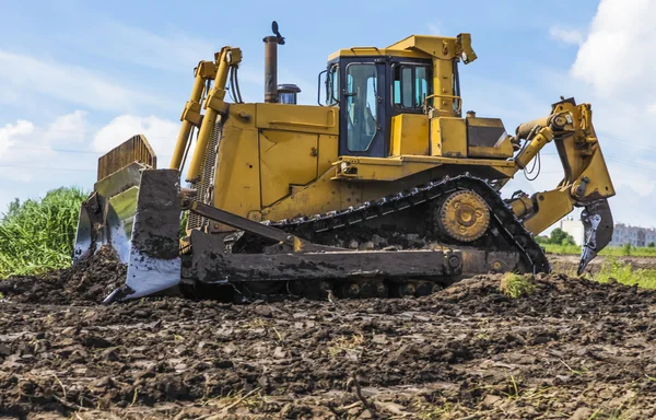 Bulldozer tractor works at moving soil