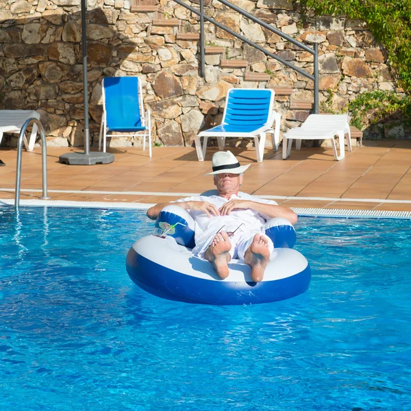 Wealthy man in swimming pool