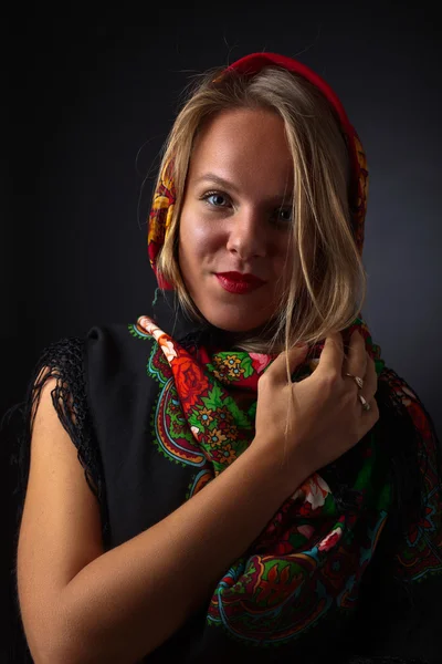Beautiful woman in a red traditional Russian shawl