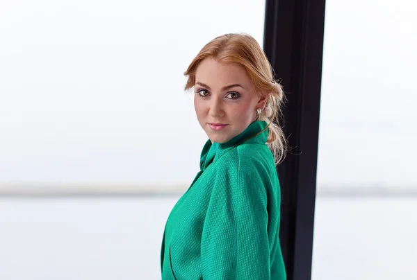 Young beautiful woman in green jacket