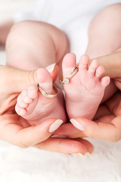 Baby feet with wedding rings