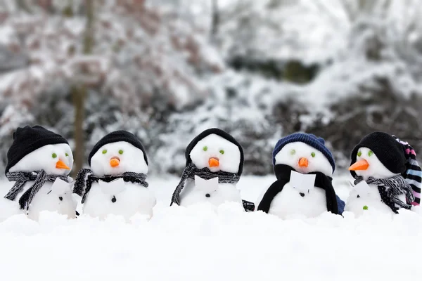 Cute snowman group in snow