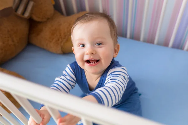 Baby boy sitting in the crib