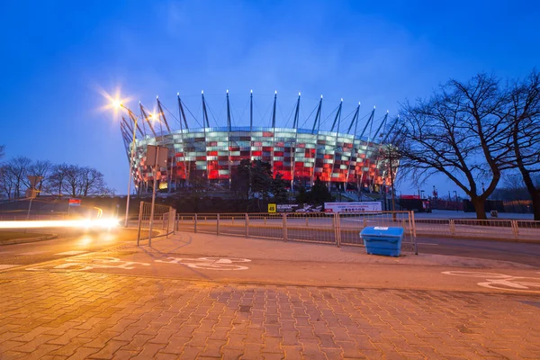 National Stadium in Warsaw illuminated at night by national colors, Poland