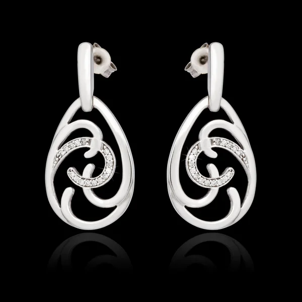 White gold earrings with diamond isolated on the black background