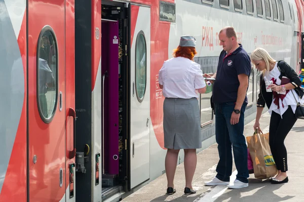 Moscow, Russia - June 14.2016. conductor checks the tickets and documents when boarding the train