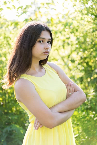 14 year old girl with crossed arms on chest