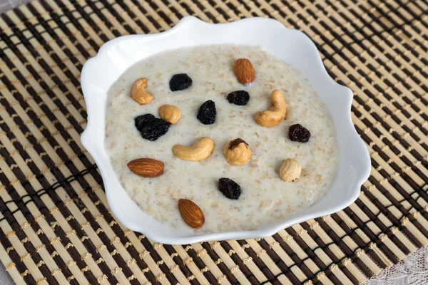 Milk oatmeal with nuts and raisins