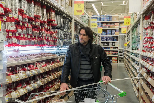 MOSCOW, RUSSIA - MARCH 03, 2015. man makes purchase of Leroy Merlin Store. Leroy Merlin is a French home-improvement and gardening retailer serving thirteen countries
