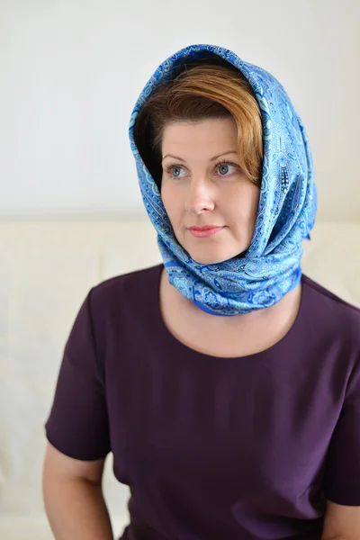 Portrait of a woman in  headscarf. Russian style.
