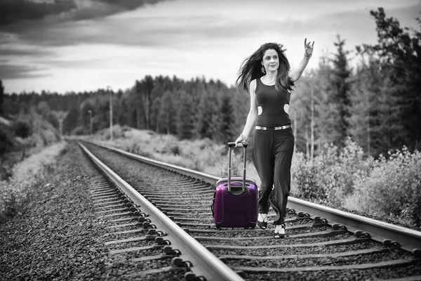 Brunette woman run after train