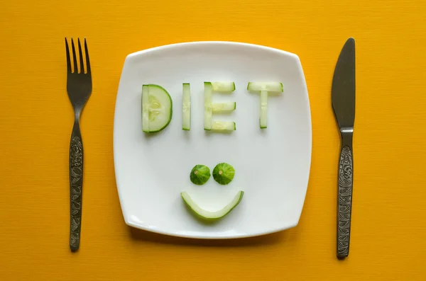 Diet and a smiling face made of cucumber