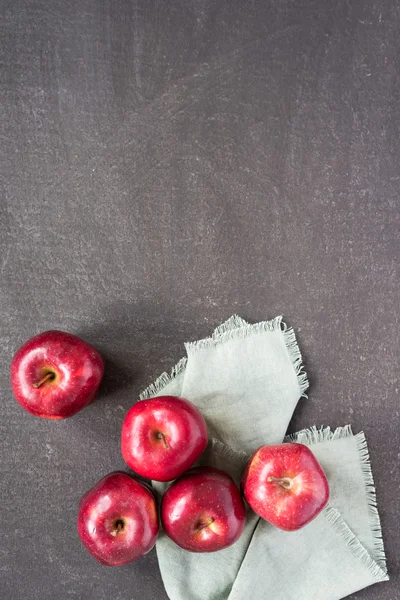 Red apples on a painted background