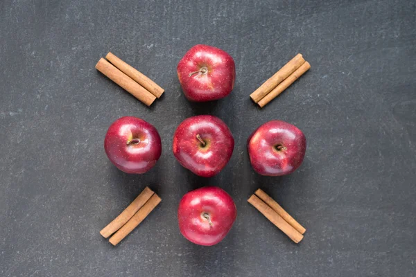 Five red apples and cinnamon